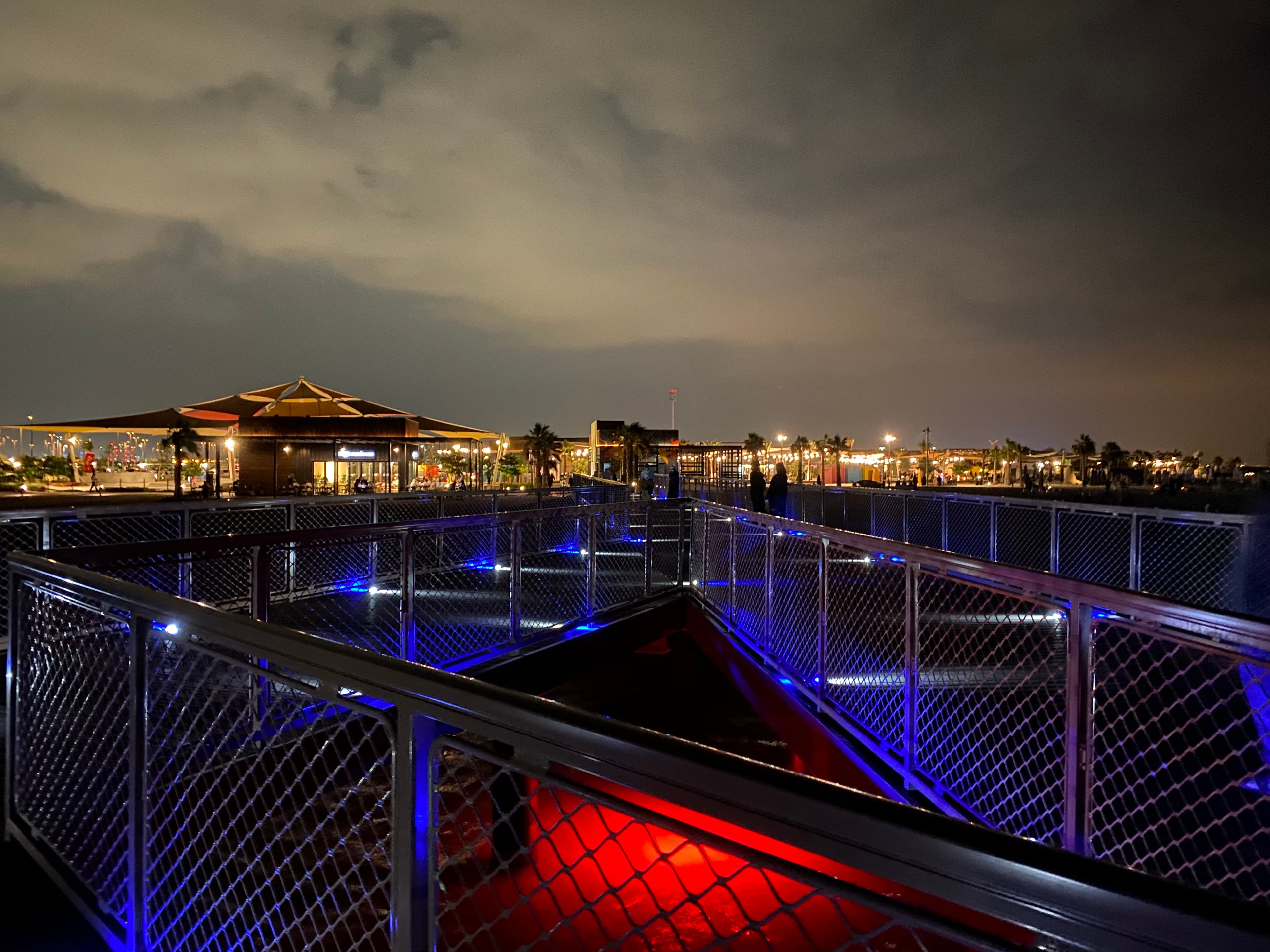 The illuminated waterfront at Hudayriyat Island after sunset
