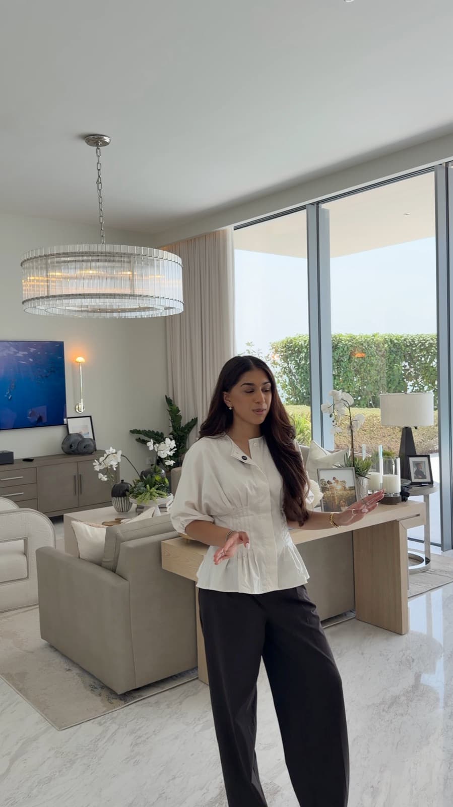 Janvi showing the living room of a furnished villa